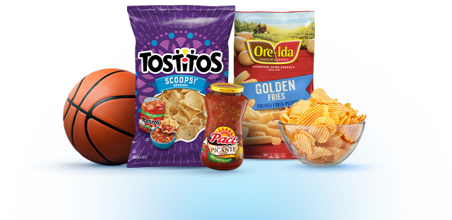 A basketball next to a bag of Tostitos tortilla chips, Ore-Ida fries, Pace salsa, and a bowl of wavy potato chips.