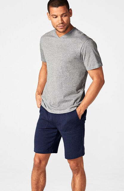 man in gray t-shirt and blue shorts man in gray t-shirt and blue shorts