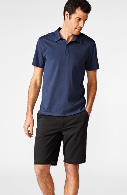man in blue polo and black shorts man in blue polo and black shorts
