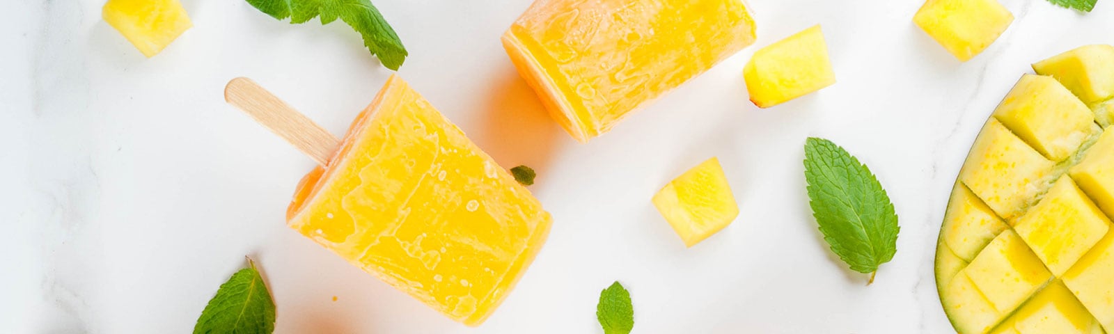 Cut up fruit freezed into popsicles on a stick Cut up fruit freezed into popsicles on a stick