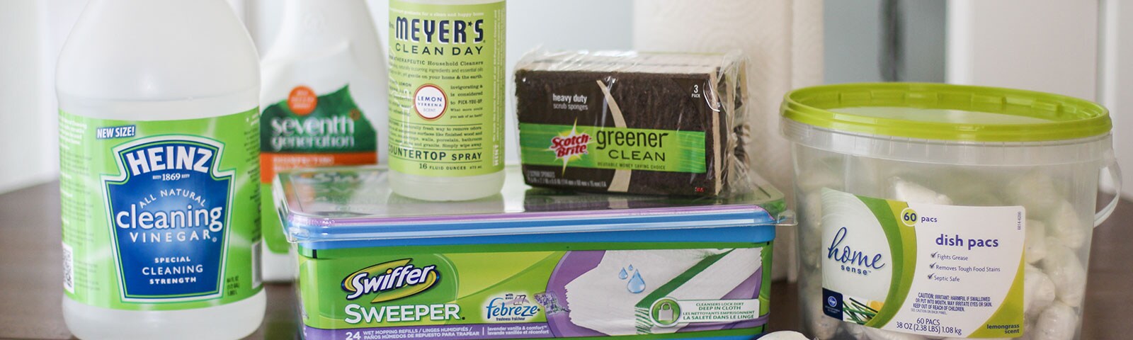 Cleaning supplies on a wooden table Cleaning supplies on a wooden table