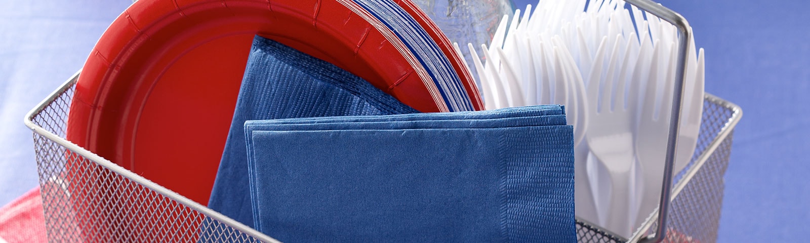 Paper plates and napkins in a wire basket Paper plates and napkins in a wire basket